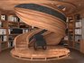 wooden spiral staircase in a room with bookshelves - Thumbnail 1