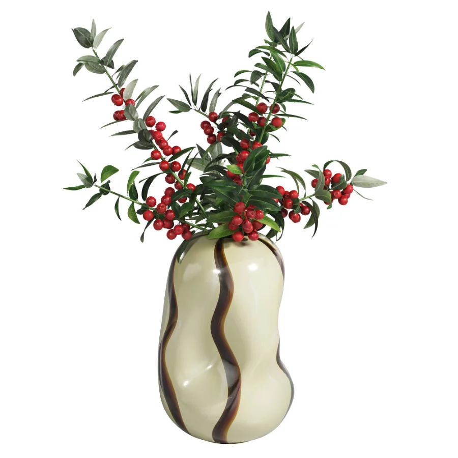 Decorative floral arrangement with red berries and green foliage in a sculptural vase (Skimmia) Image 3